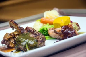 fine-dining-dish-featuring-grilled-meats,-vegetables,-and-sauces